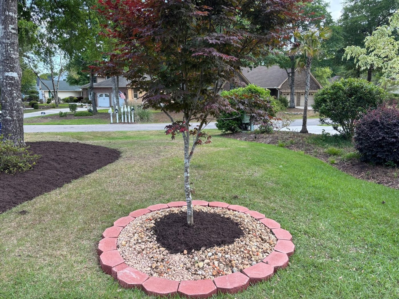 Fresh mulch and landscaped beds by On Edge Lawn Care